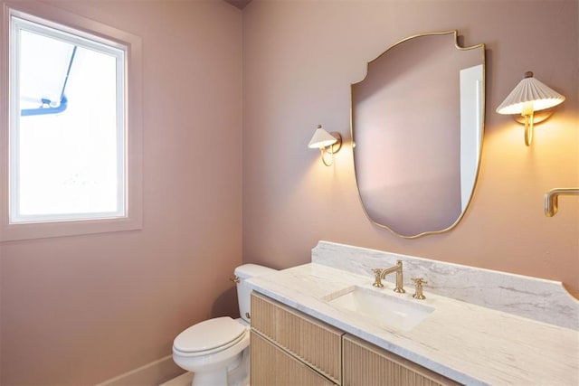 half bathroom with vanity and toilet