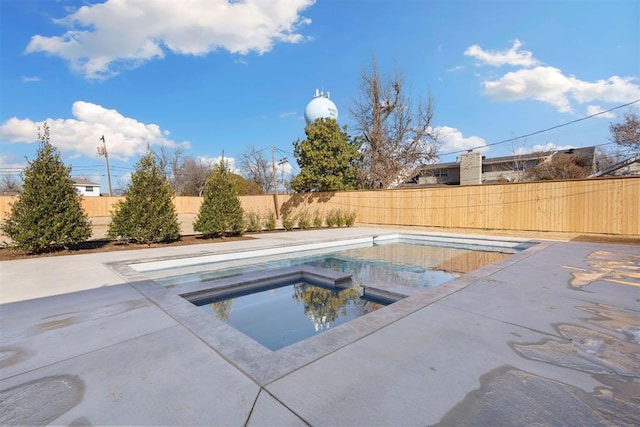 view of swimming pool featuring a fenced in pool, a patio area, a fenced backyard, and an in ground hot tub