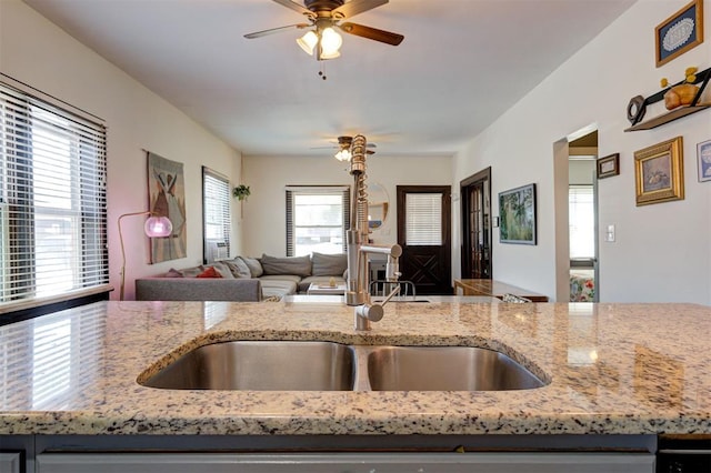 1721 NW 29th St, Oklahoma City, OK 73106 - kitchen featuring a sink, open floor plan, light stone counters, and a ceiling fan