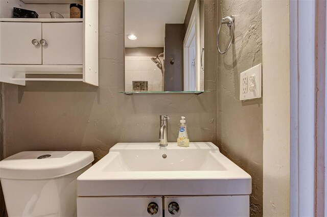 1721 NW 29th St, Oklahoma City, OK 73106 - bathroom with a textured wall, toilet, and vanity