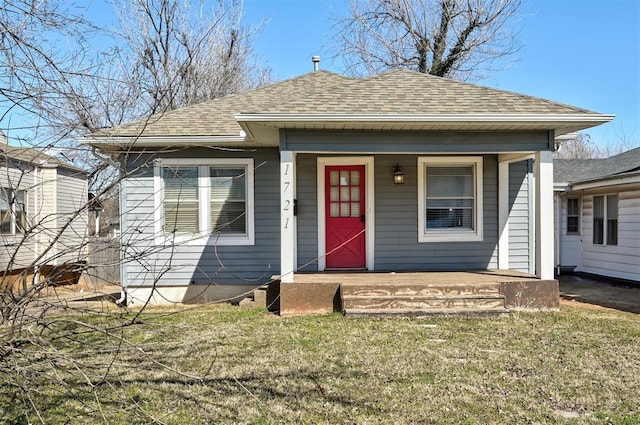 1721 NW 29th St, Oklahoma City, OK 73106 - bungalow-style home with covered porch, roof with shingles, and a front lawn