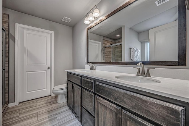 bathroom with a sink, visible vents, and a shower stall