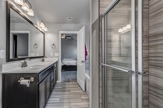 bathroom with double vanity, visible vents, a ceiling fan, ensuite bath, and a sink