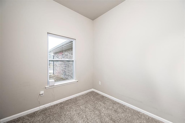 unfurnished room featuring carpet floors and baseboards