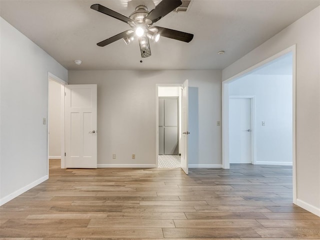 unfurnished room featuring light wood-type flooring, visible vents, ceiling fan, and baseboards