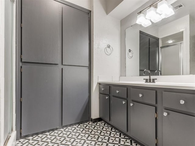 bathroom with visible vents, vanity, and tile patterned floors