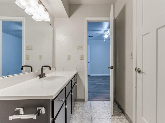 bathroom with visible vents, a ceiling fan, vanity, baseboards, and tile patterned floors