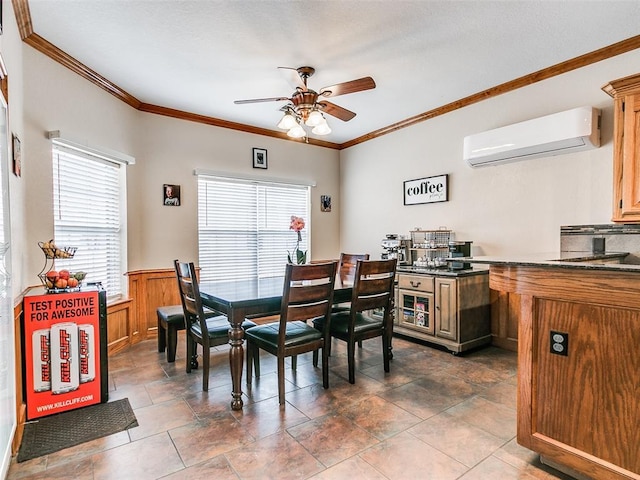 dining area with a ceiling fan, ornamental molding, an AC wall unit, and wainscoting