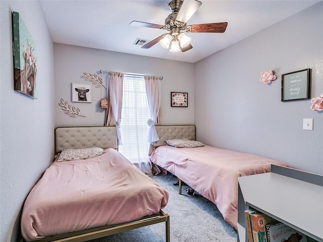 carpeted bedroom with ceiling fan and visible vents