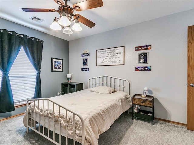 bedroom featuring ceiling fan, carpet floors, visible vents, and baseboards