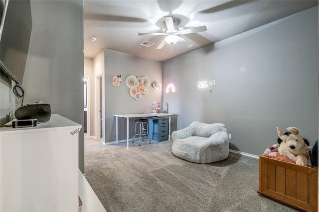 living area featuring visible vents, baseboards, a ceiling fan, and carpet flooring