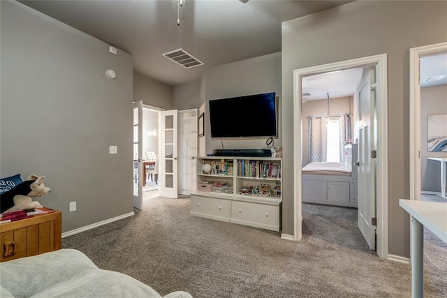 carpeted living room with visible vents, french doors, and baseboards