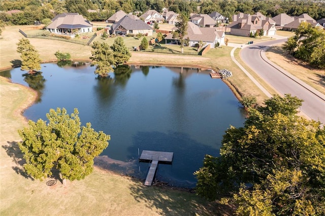 drone / aerial view featuring a residential view and a water view