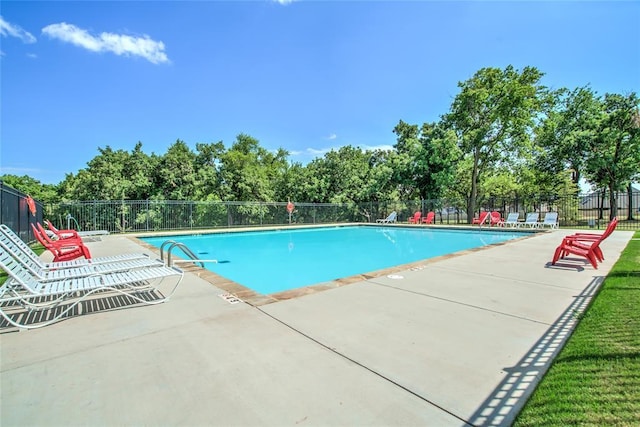 pool featuring a patio area and fence