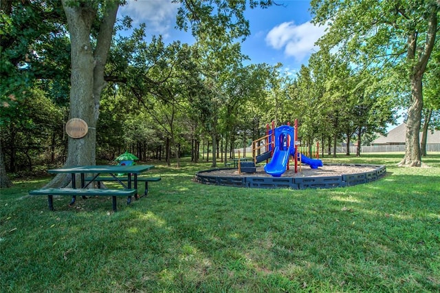 community jungle gym featuring a lawn