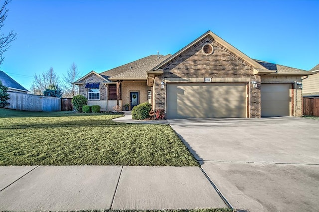 ranch-style home featuring a garage, a front yard, concrete driveway, and brick siding