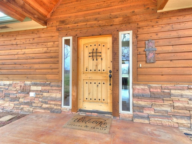 property entrance with stone siding