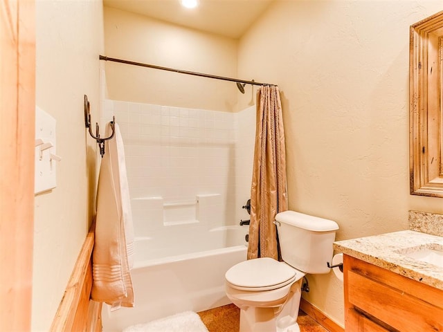 full bathroom featuring shower / bath combination with curtain, a textured wall, vanity, and toilet