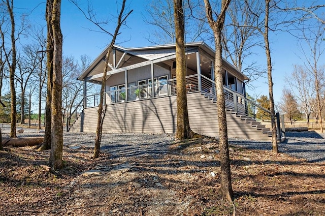 view of home's exterior with driveway and stairs