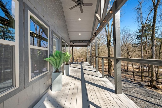 wooden terrace featuring ceiling fan