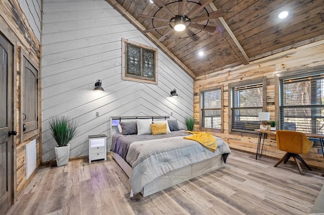 bedroom featuring high vaulted ceiling, wooden ceiling, wooden walls, and wood finished floors