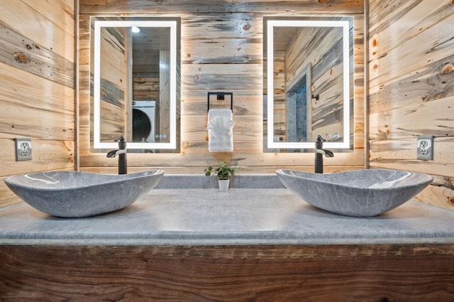 bathroom with vanity and wooden walls