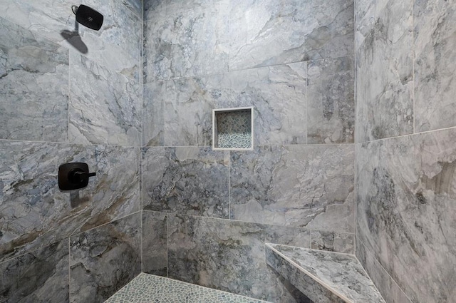 bathroom with a tile shower