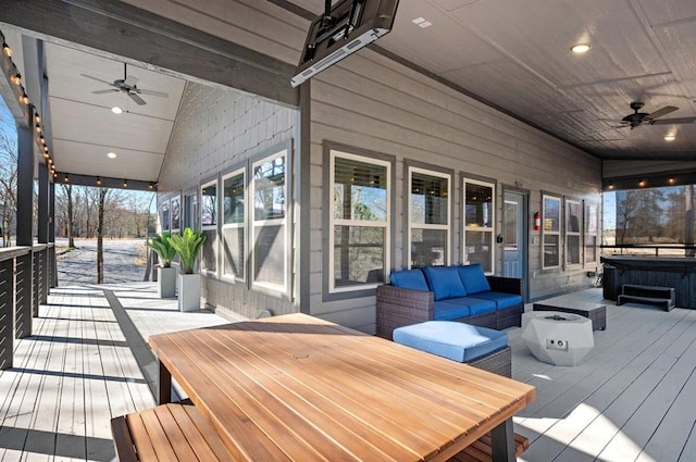 wooden deck with outdoor dining space, outdoor lounge area, a ceiling fan, and a hot tub