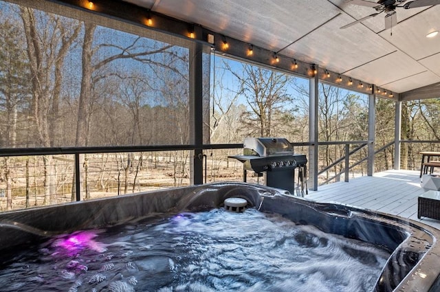 wooden terrace featuring a hot tub, ceiling fan, and area for grilling