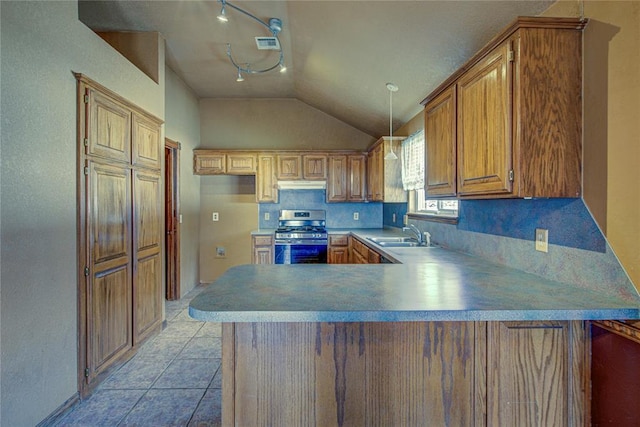 kitchen with lofted ceiling, light tile patterned flooring, a peninsula, gas range, and under cabinet range hood