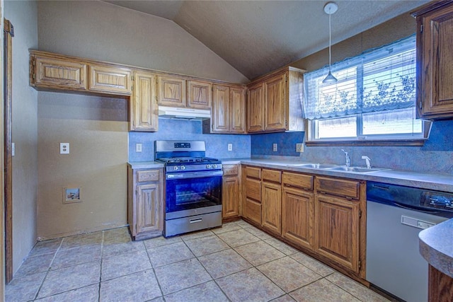 kitchen featuring lofted ceiling, backsplash, appliances with stainless steel finishes, a sink, and under cabinet range hood