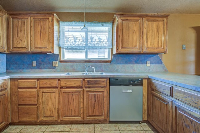 kitchen with light tile patterned floors, brown cabinetry, dishwasher, and light countertops