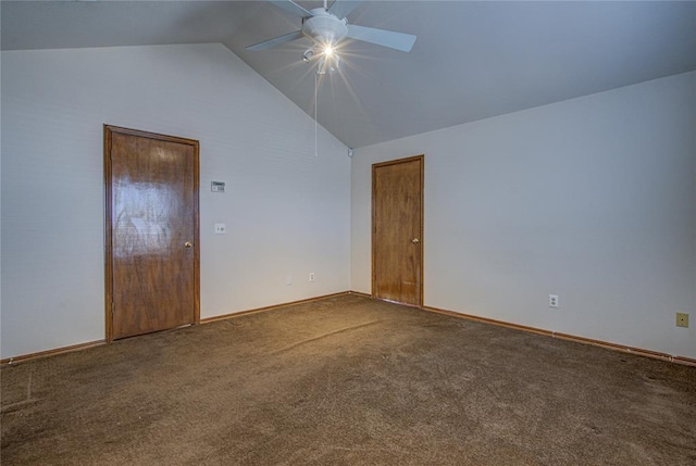 carpeted spare room with ceiling fan, baseboards, and vaulted ceiling