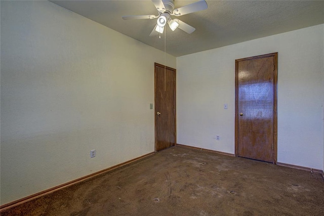 spare room featuring a textured ceiling, carpet flooring, a ceiling fan, and baseboards