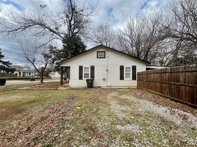 rear view of house with fence