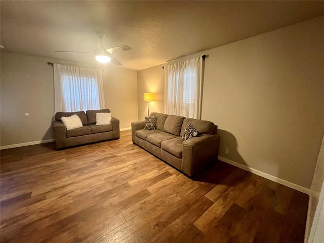 living room featuring ceiling fan, wood finished floors, a wealth of natural light, and baseboards