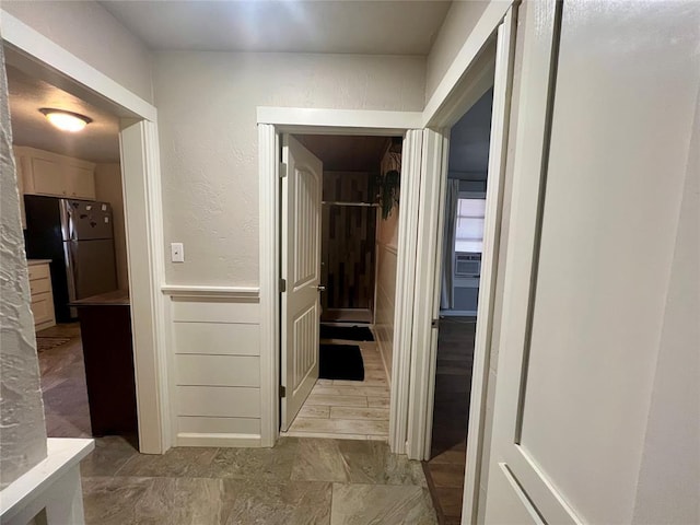 hallway with cooling unit and a textured wall