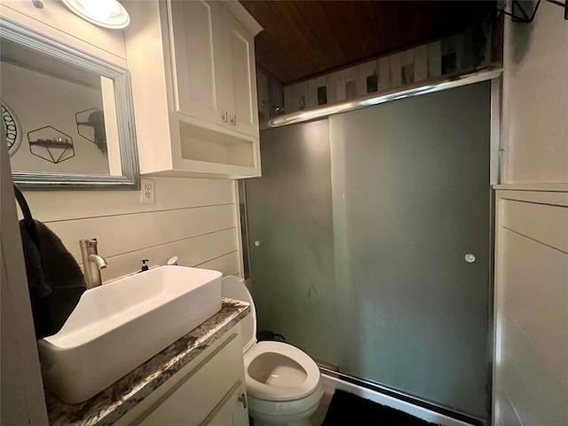 bathroom featuring a stall shower, wooden ceiling, vanity, and toilet