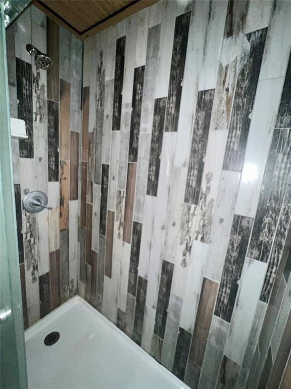 bathroom with a tile shower