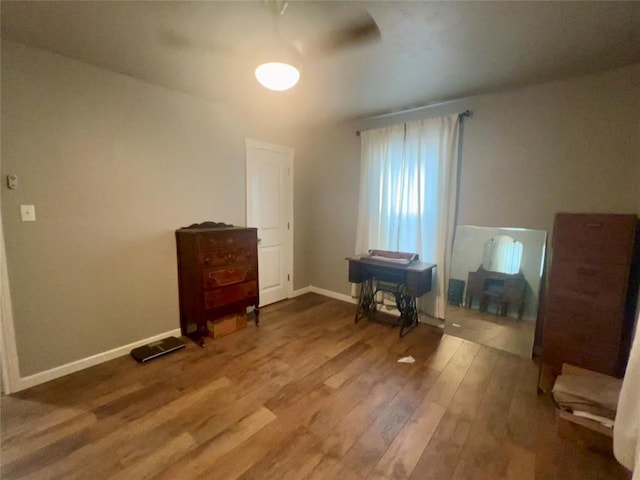 miscellaneous room with baseboards and wood finished floors