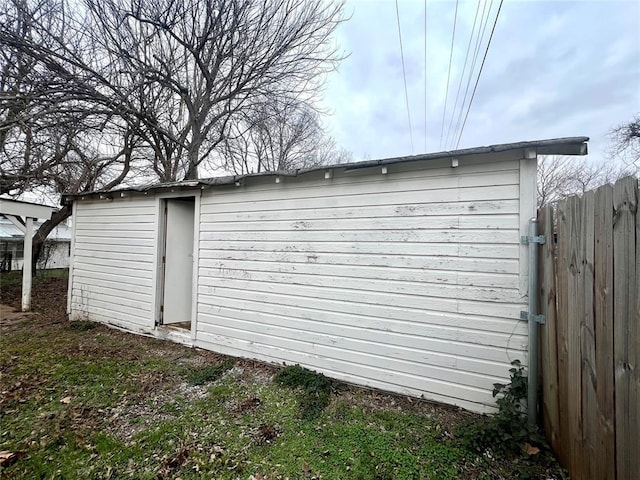 view of outbuilding featuring an outbuilding and fence