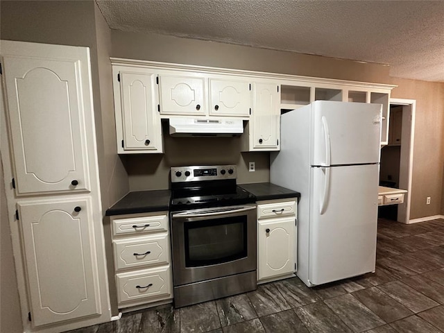 kitchen with freestanding refrigerator, dark countertops, under cabinet range hood, and stainless steel electric range