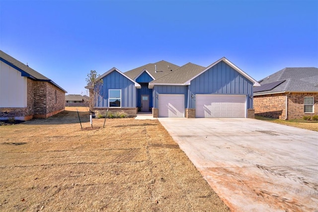 view of front of home with a garage, driveway, and board and batten siding