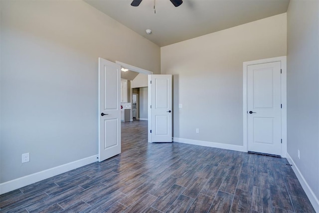 unfurnished bedroom with dark wood finished floors, a ceiling fan, and baseboards