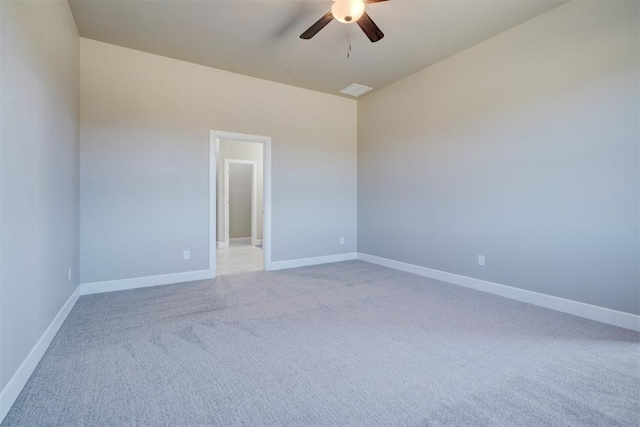 unfurnished room featuring ceiling fan, baseboards, and light colored carpet