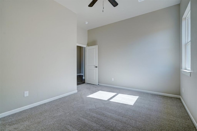 unfurnished room featuring light carpet, ceiling fan, and baseboards