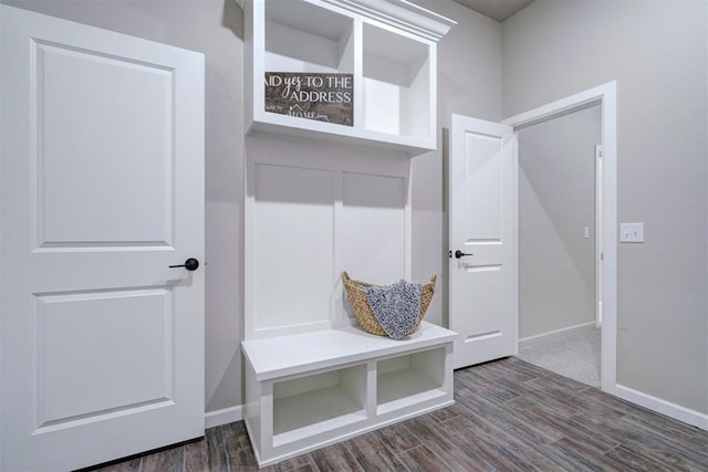 mudroom featuring baseboards and dark wood-style flooring