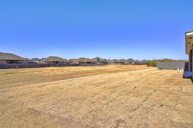 view of yard with a residential view and fence