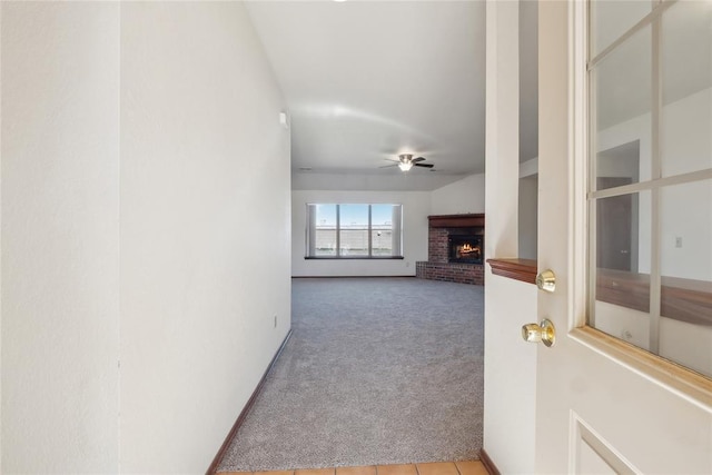 unfurnished living room featuring carpet flooring, a fireplace, and ceiling fan