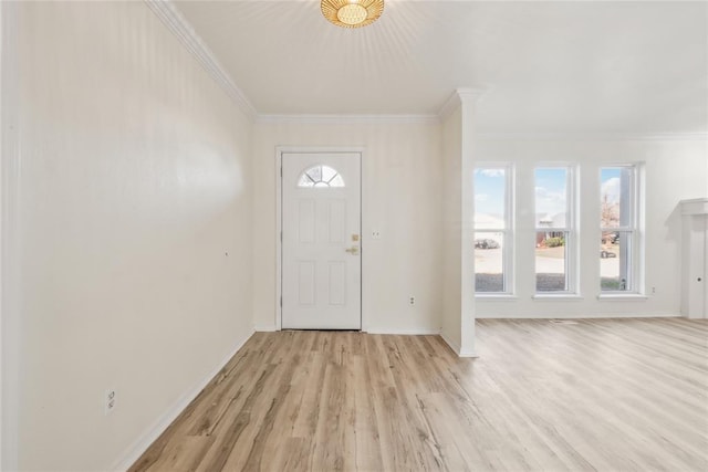 foyer entrance with light wood-type flooring, crown molding, and baseboards